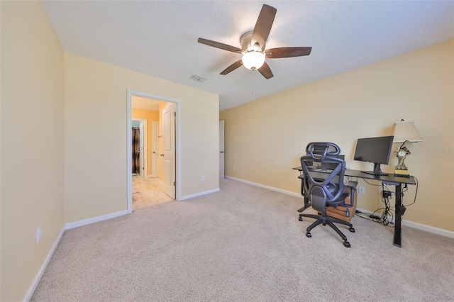 office with visible vents, ceiling fan, baseboards, and carpet