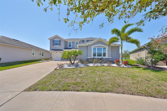 view of front of house with a garage, stucco siding, concrete driveway, and a front lawn