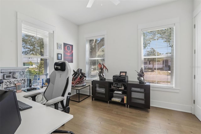 home office featuring a wealth of natural light, wood-type flooring, and a ceiling fan