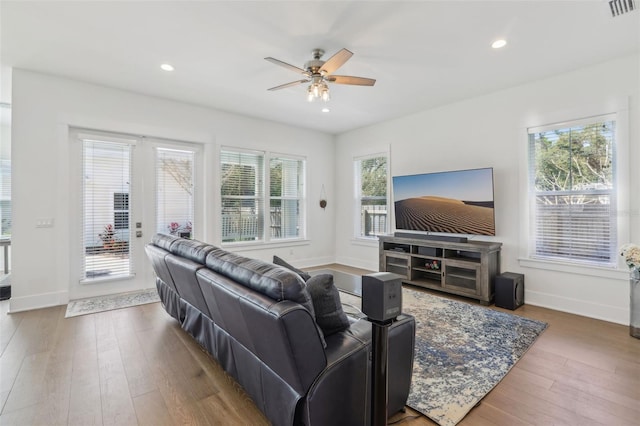 living room featuring plenty of natural light, a ceiling fan, and wood finished floors