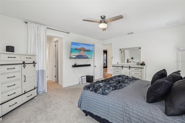 bedroom featuring visible vents, light colored carpet, baseboards, and a ceiling fan