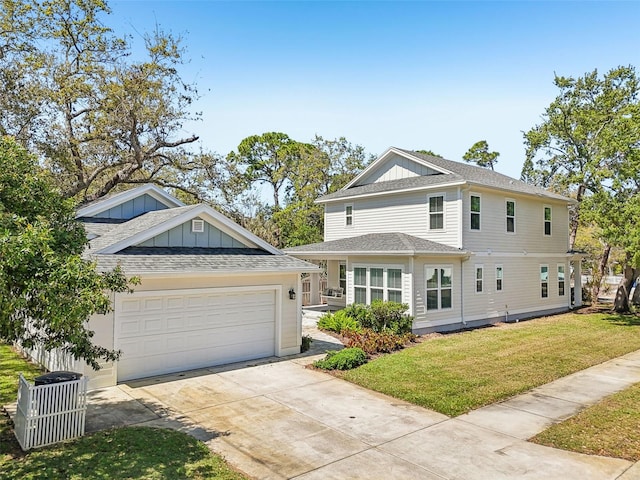 view of front of property with a front yard, roof with shingles, an attached garage, concrete driveway, and central air condition unit