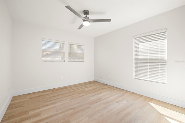 unfurnished room featuring light wood finished floors, a ceiling fan, and baseboards