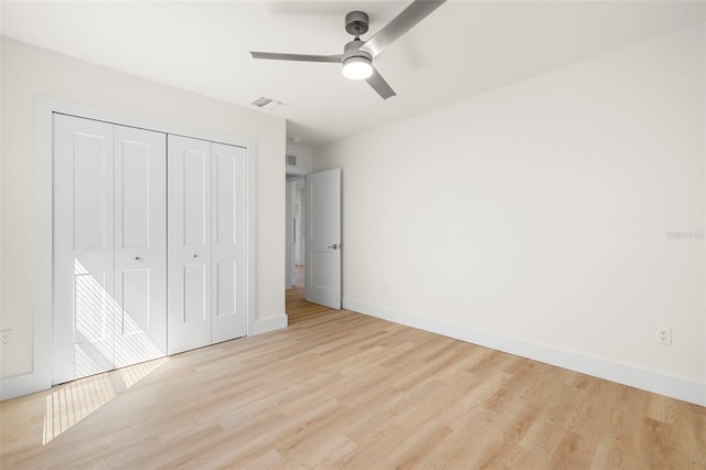 unfurnished bedroom with visible vents, baseboards, light wood-style flooring, a closet, and a ceiling fan