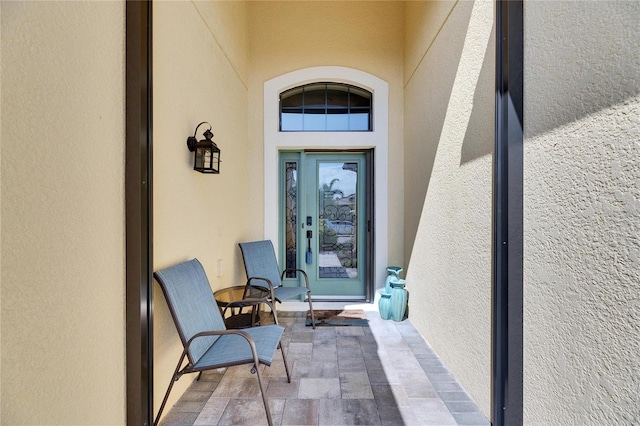 doorway to property featuring stucco siding