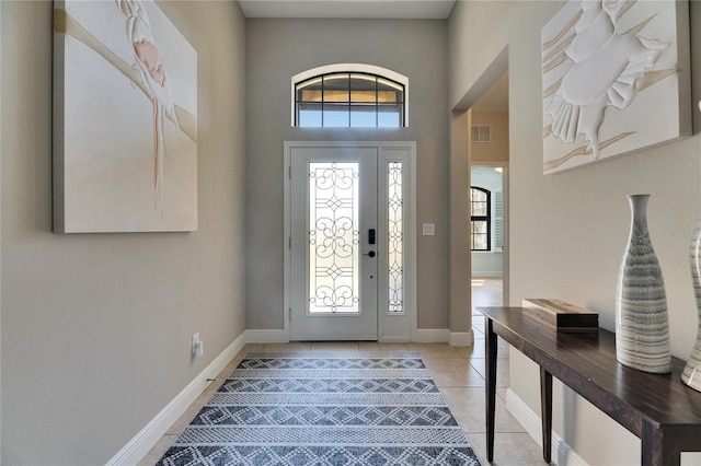 entryway featuring light tile patterned flooring, visible vents, and baseboards