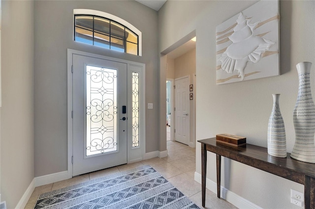 entrance foyer featuring light tile patterned flooring and baseboards