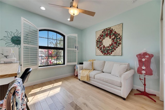 living room with a ceiling fan, recessed lighting, baseboards, and light wood-type flooring