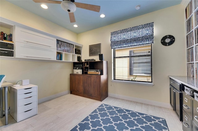 home office with light wood-style flooring, baseboards, and ceiling fan