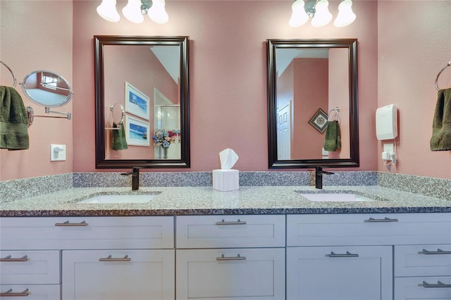 full bathroom featuring double vanity and a sink