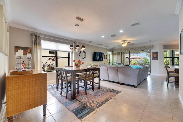 dining space with visible vents, baseboards, ornamental molding, light tile patterned floors, and ceiling fan with notable chandelier