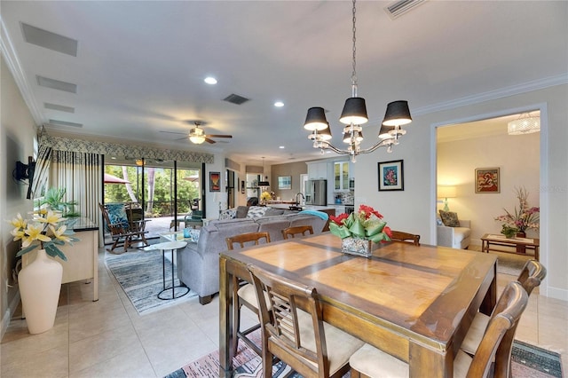 dining space featuring light tile patterned floors, visible vents, ornamental molding, and ceiling fan with notable chandelier