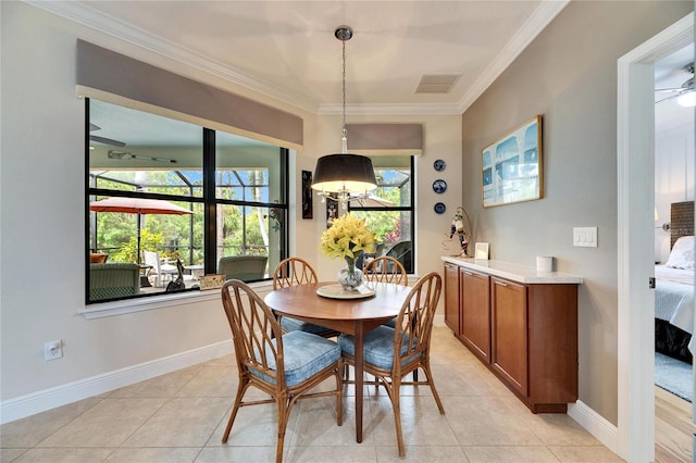 dining room featuring crown molding, light tile patterned floors, baseboards, and visible vents