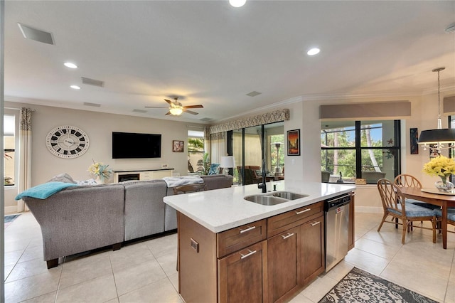 kitchen featuring visible vents, a sink, crown molding, light countertops, and dishwasher