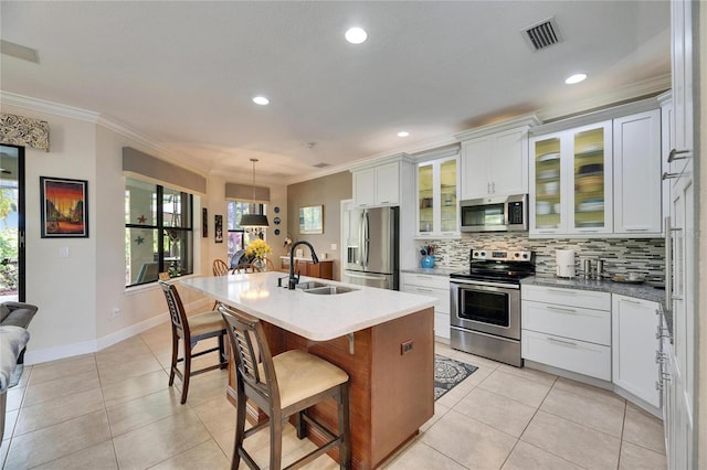 kitchen featuring a sink, stainless steel appliances, visible vents, and light tile patterned floors