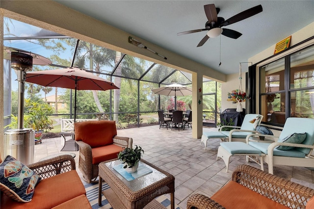 view of patio / terrace with outdoor dining space, an outdoor living space, glass enclosure, and ceiling fan