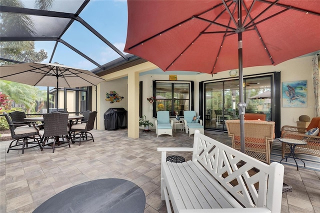 view of patio / terrace with grilling area, glass enclosure, an outdoor hangout area, and outdoor dining area