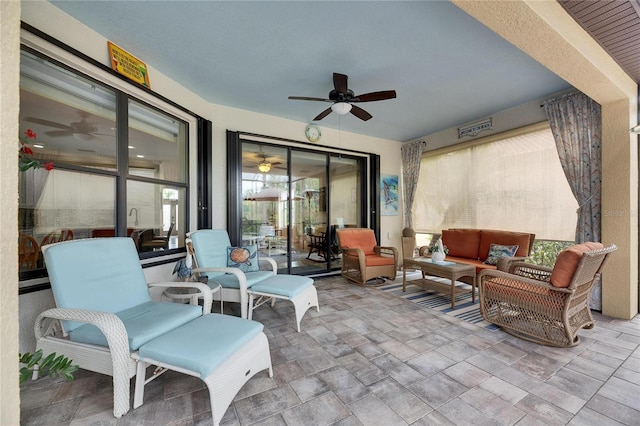 view of patio with outdoor lounge area and a ceiling fan