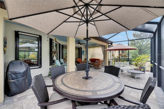 view of patio with a lanai, an outdoor hangout area, outdoor dining space, a grill, and a ceiling fan