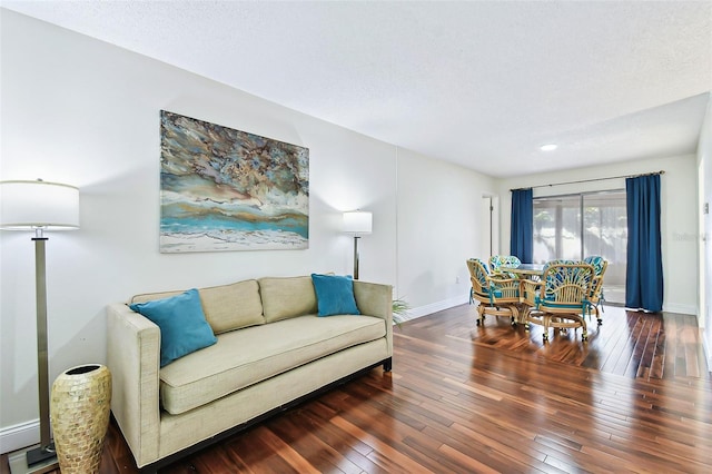 living area with baseboards and wood-type flooring