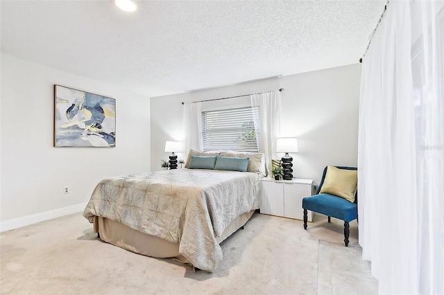 bedroom featuring baseboards, light colored carpet, radiator heating unit, and a textured ceiling
