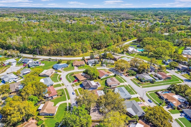 bird's eye view featuring a residential view and a wooded view