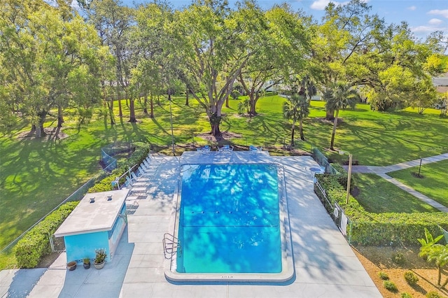 view of pool with a yard