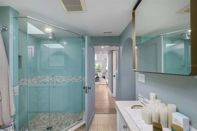 bathroom with vanity, a shower stall, visible vents, and tile patterned flooring