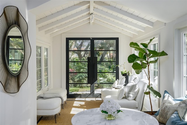 sunroom / solarium featuring beamed ceiling, plenty of natural light, and french doors
