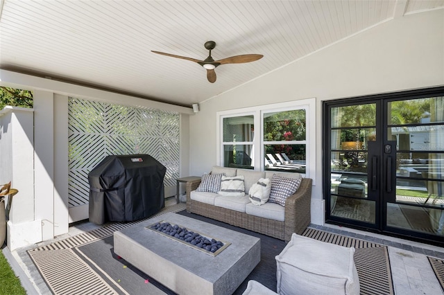 view of patio / terrace with a grill, french doors, an outdoor living space with a fire pit, and ceiling fan
