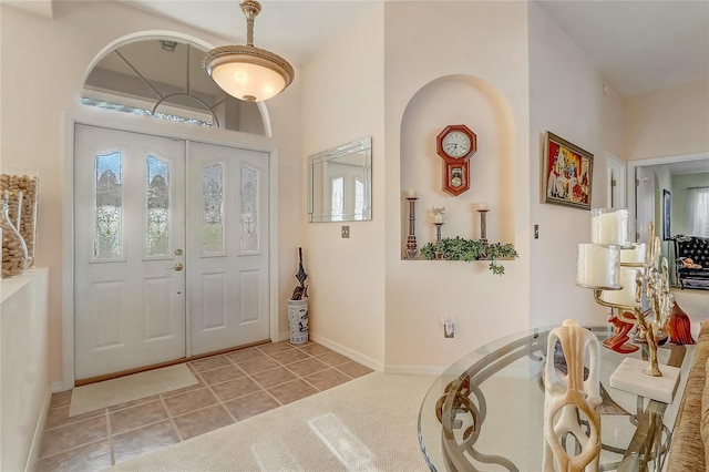 foyer entrance featuring tile patterned flooring and baseboards