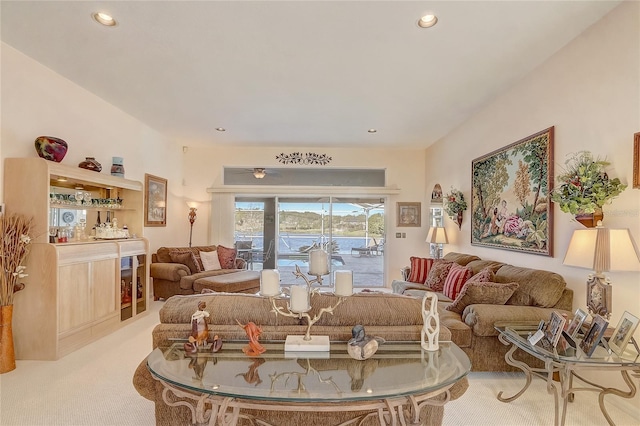 carpeted living room with recessed lighting and a bar