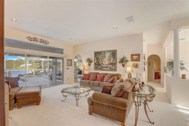 living room featuring carpet, recessed lighting, visible vents, and arched walkways