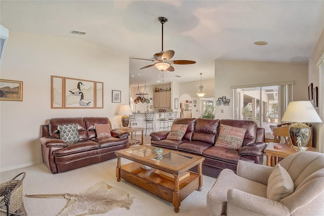 carpeted living area with visible vents, baseboards, lofted ceiling, and a ceiling fan