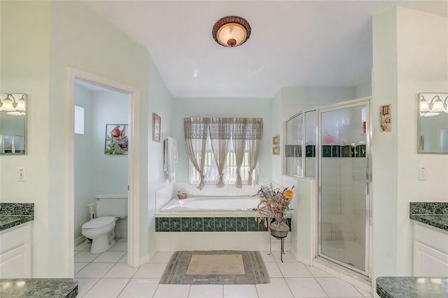 bathroom with vanity, tile patterned floors, toilet, and a shower stall