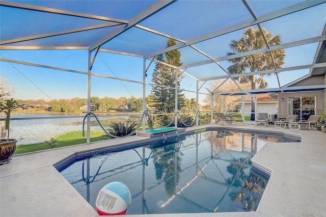 pool with a patio, a lanai, and a water view