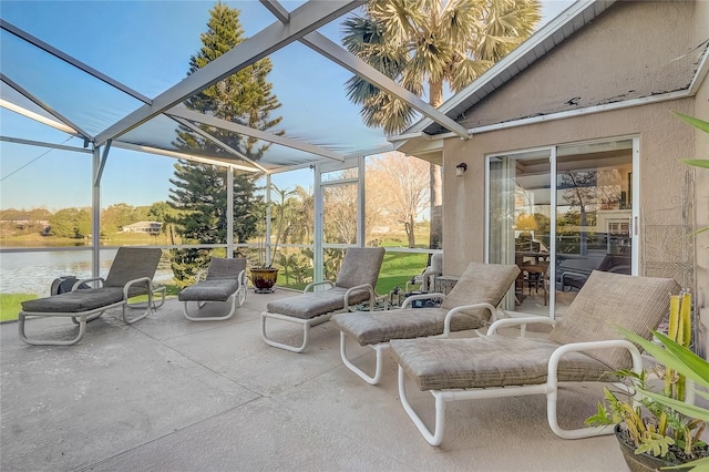 view of patio / terrace with glass enclosure and a water view