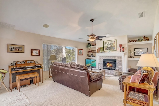 10837 Versailles Blvd, Clermont, FL 34711 - living room with ceiling fan, light colored carpet, and a tile fireplace
