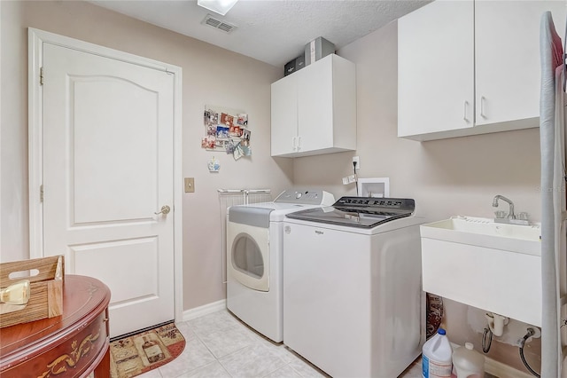 10837 Versailles Blvd, Clermont, FL 34711 - laundry area with washing machine and clothes dryer, cabinet space, and light tile patterned floors