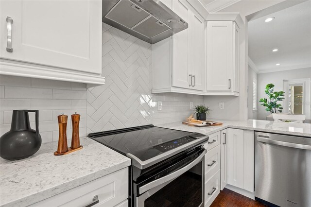 445 29th Ave N, Saint Petersburg, FL 33704 - kitchen featuring stainless steel appliances, under cabinet range hood, ornamental molding, decorative backsplash, and light stone counters
