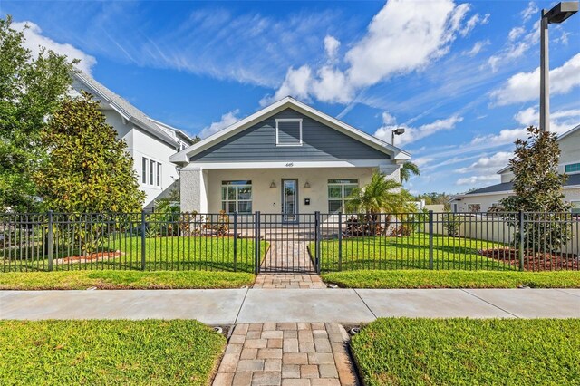 445 29th Ave N, Saint Petersburg, FL 33704 - view of front of home with a gate, stucco siding, and a porch