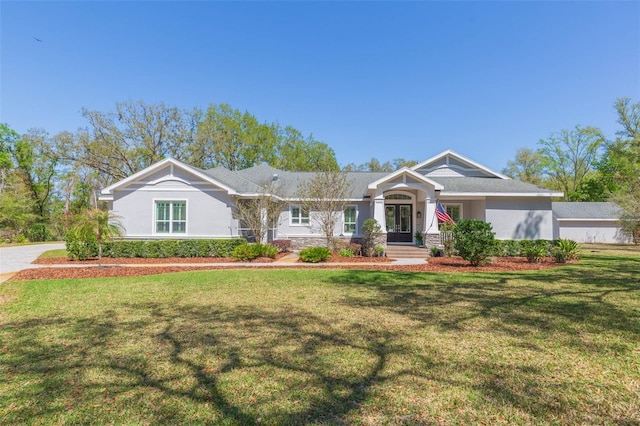 view of front of property with stucco siding and a front yard