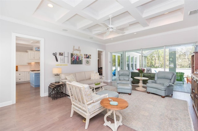 living area featuring light wood finished floors, visible vents, coffered ceiling, and ornamental molding