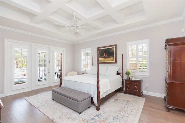 bedroom with multiple windows, coffered ceiling, light wood-style floors, and access to outside