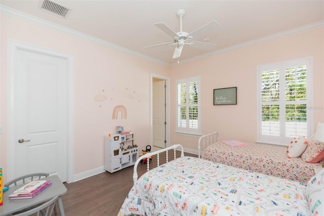 bedroom featuring dark wood-type flooring, baseboards, visible vents, and ornamental molding