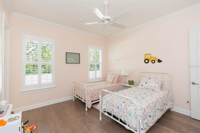 bedroom featuring wood finished floors, baseboards, and ornamental molding