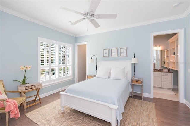 bedroom featuring connected bathroom, wood finished floors, baseboards, and ornamental molding