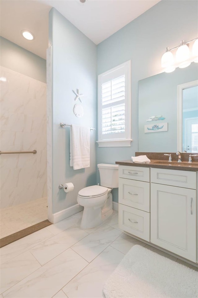 full bath featuring a marble finish shower, baseboards, toilet, marble finish floor, and vanity