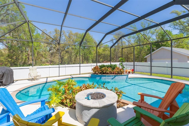 view of swimming pool featuring a fenced in pool, a patio, a fenced backyard, and glass enclosure