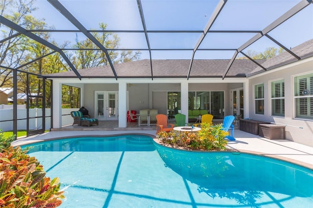 view of swimming pool featuring a patio area, a fenced in pool, french doors, and an outdoor fire pit